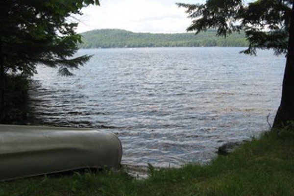 View of sandy beach/.lake to left of dock
