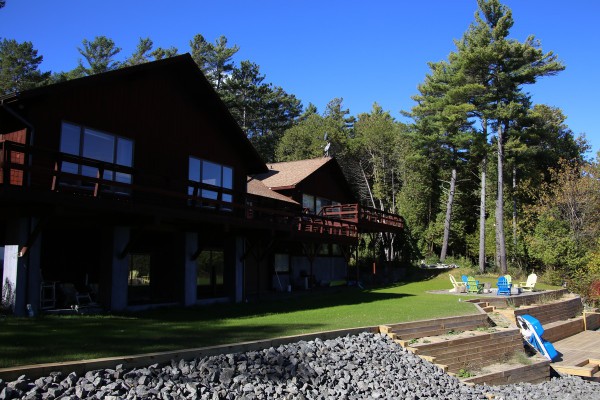 Home and new lakefront deck with steps down to lake