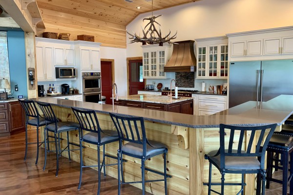 Chefs kitchen with island and dining bar