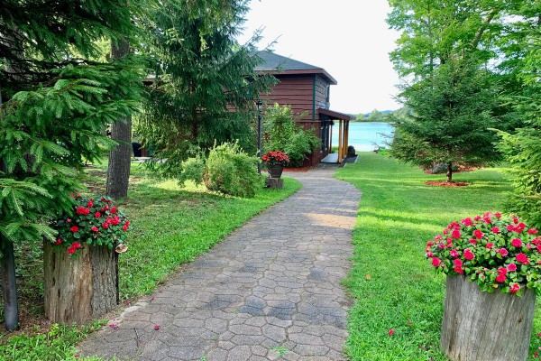 View of walkway from large parking lot to house