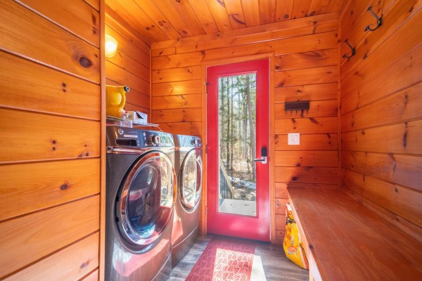 Entry has full washer/dryer with coat hooks.
