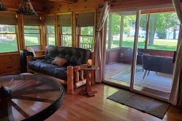 Living room with lake view and screen porch access