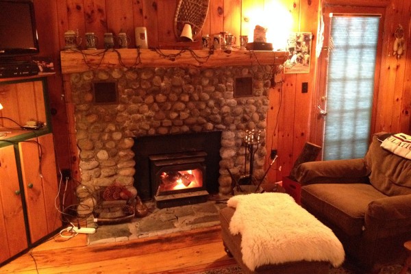 Stone hearth fireplace is focal point of the camp