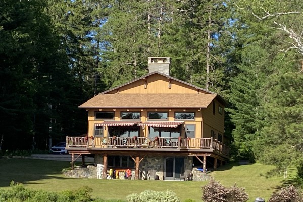 Main house with large lawn surrounded by trees!