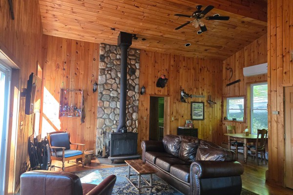 Main living area with wood stove and laundry room