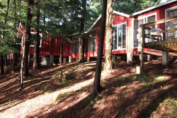 Late afternoon sun reflecting on cabin from lake