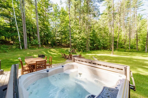 The hot tub has a lovely view to the fire pit and yard.
