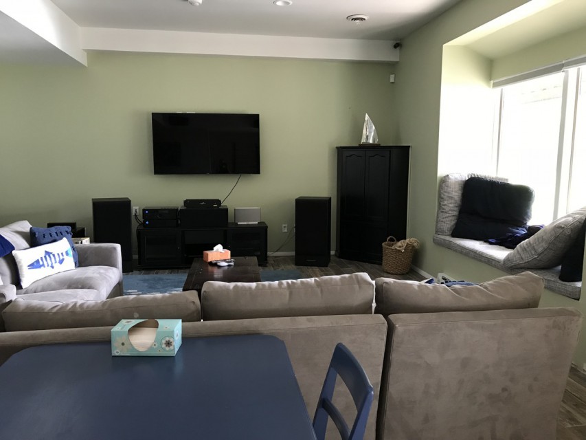 Basement game room with home theater and window seat