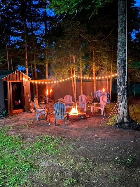 Back yard area with a swing for the kids and a fire pit