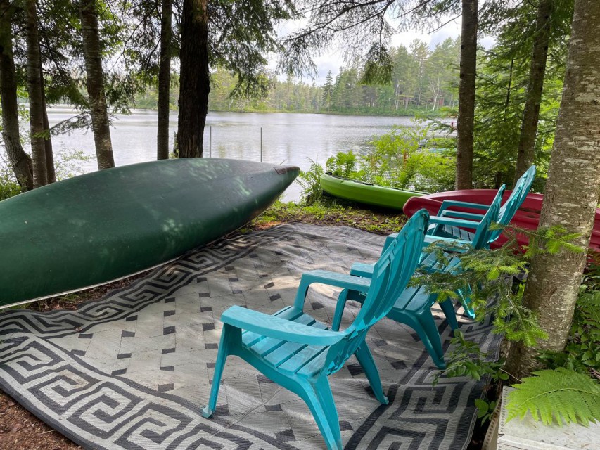 Canoe,  kayak, and sitting area by lake