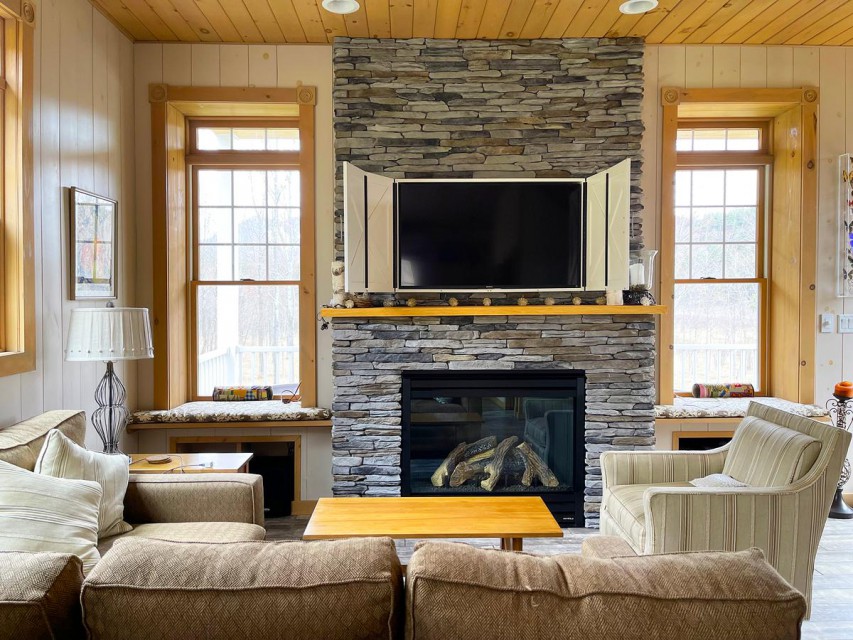 Living room with 40" gas fireplace, views of Whiteface.