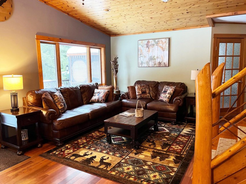 Living room with French doors to deck and water.