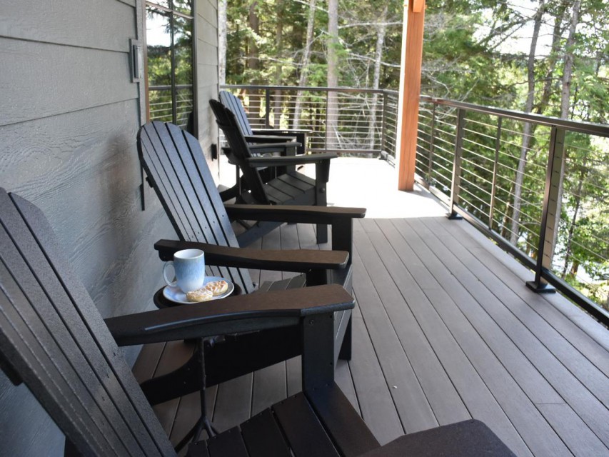 Lakefront porch and classic Adirondack chairs