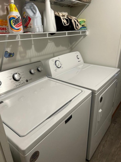 New washer and dryer in hallway.
