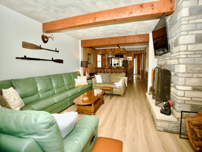 Family room off of bar area, 55 inch above fireplace