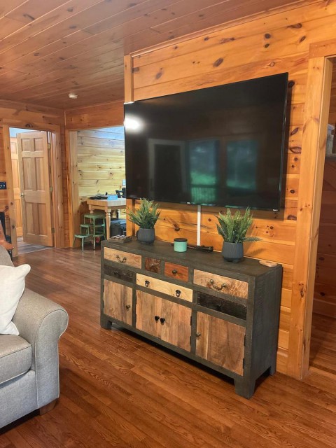 Large TV & cabinet full of board games in Main house