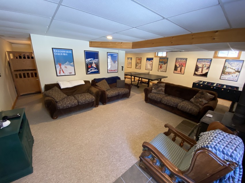 Basement rec room includes ping pong and foosball table