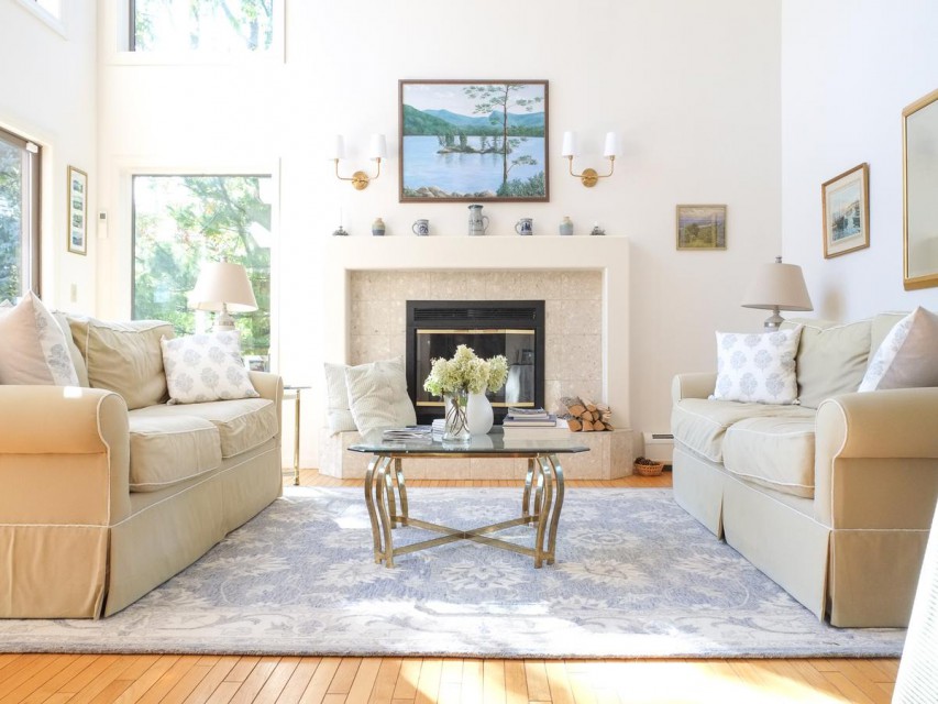 The cozy living room has gorgeous lake views