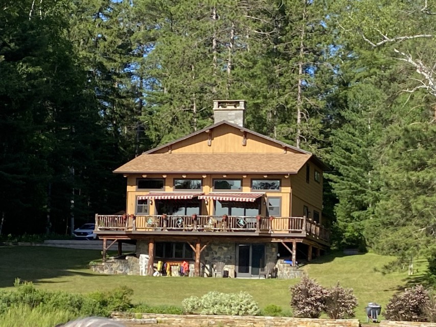 Main house with large lawn surrounded by trees!
