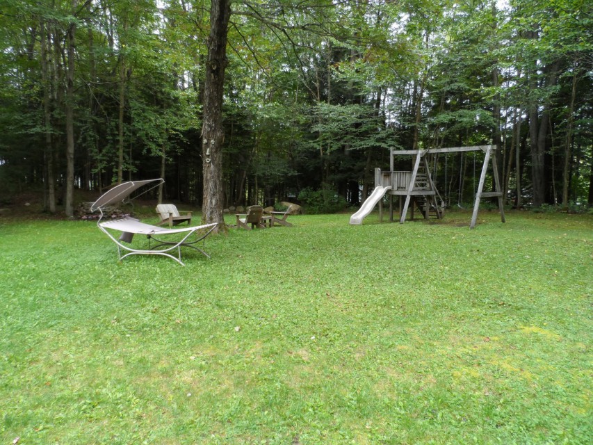 Back yard with swing-set, fire pit, hammock, ADK chairs