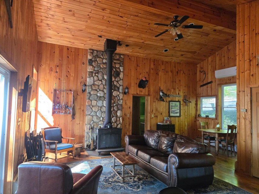 Main living area with wood stove and laundry room