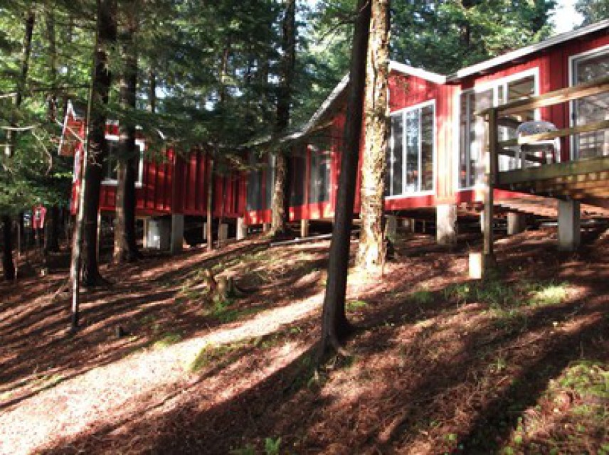 Late afternoon sun reflecting on cabin from lake