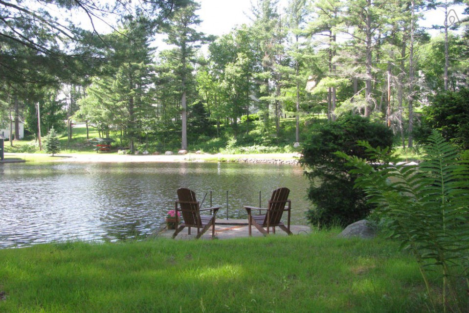 Swim dock overlooking wooded shoreline and the village 