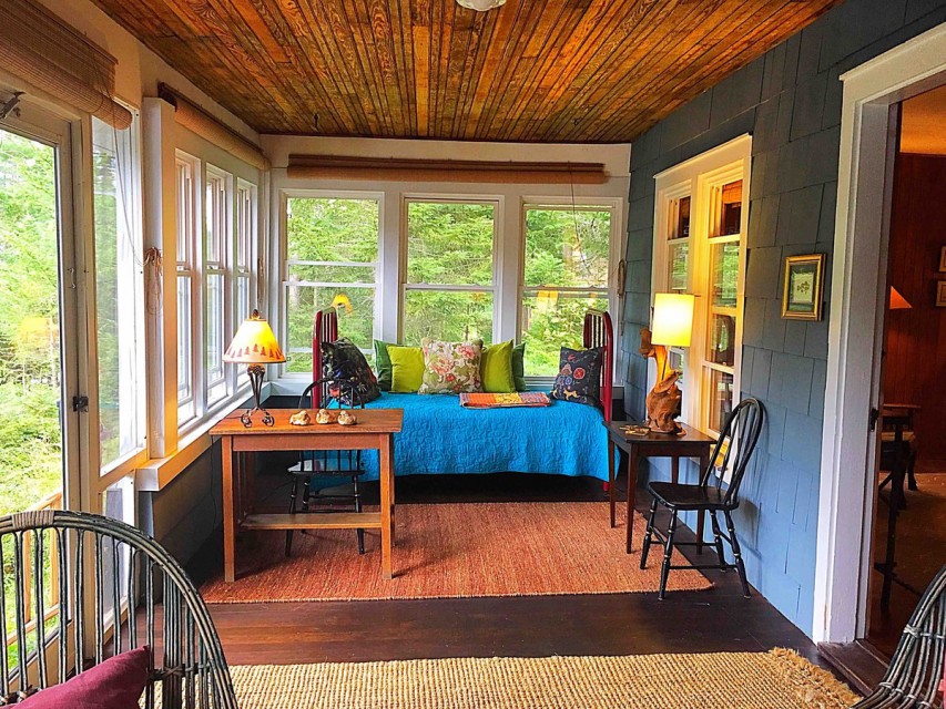Lakeside porch, daybed and desk, steps to dock