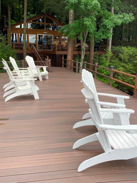 Deck above covered boat house looking at house.