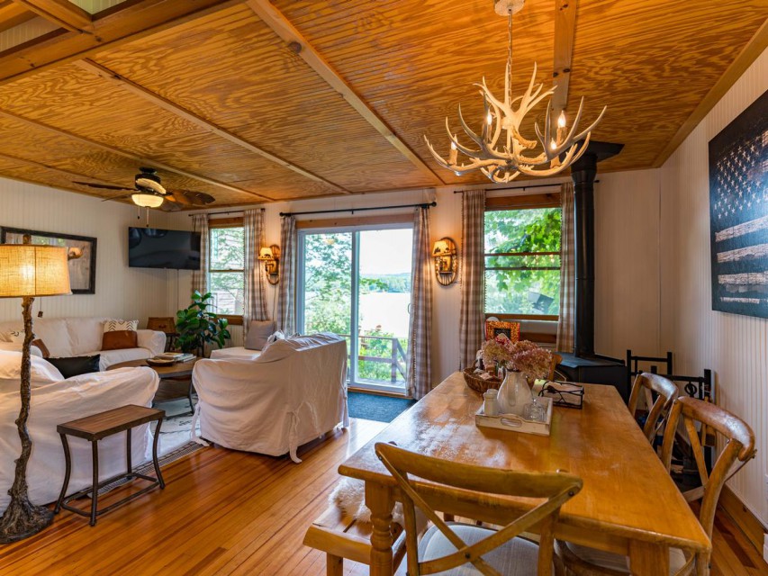 Living room w/ lake views and wood stove. 
