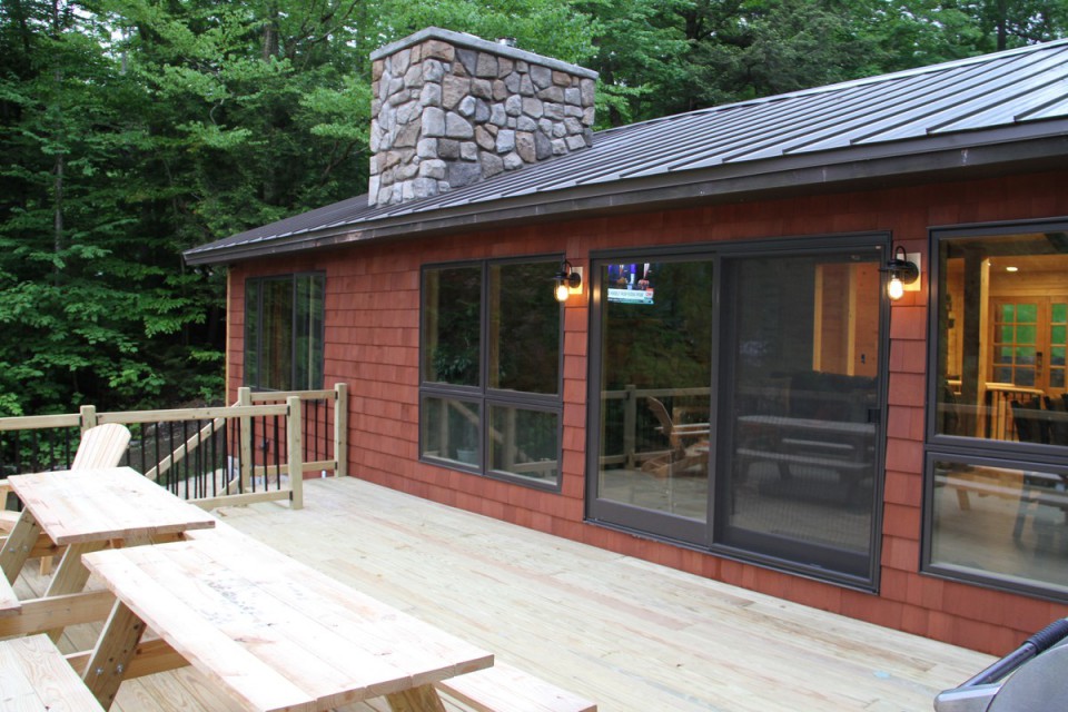 Lake facing deck with picnic tables and gas grill