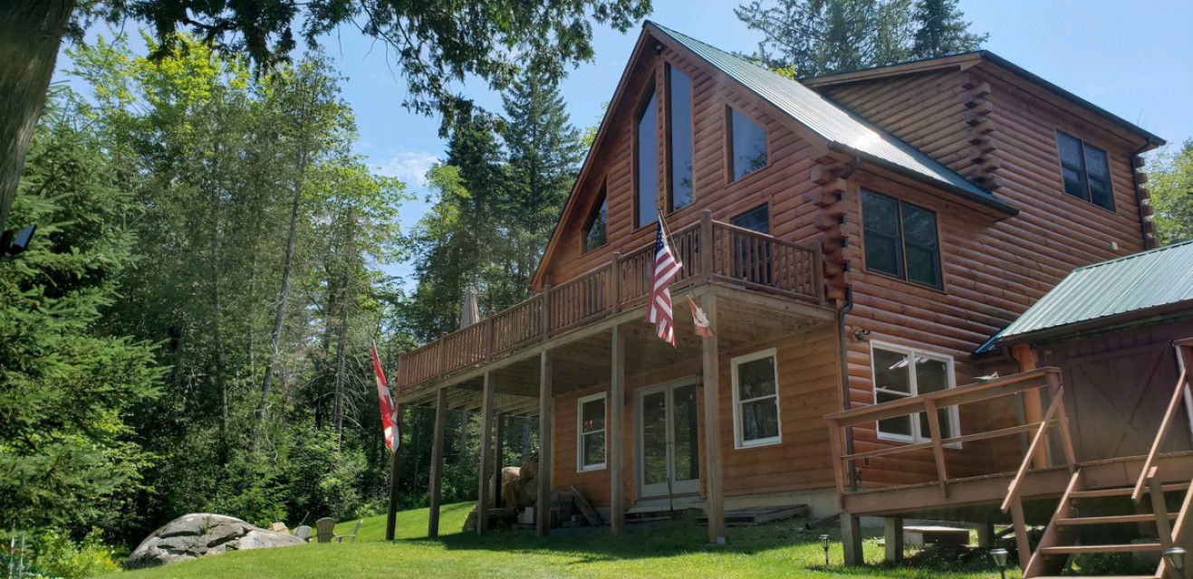 Log cabin view from shoreline
