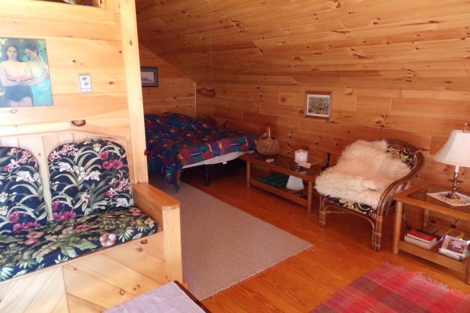 back of L-shaped upstairs room w Queen bed in corner