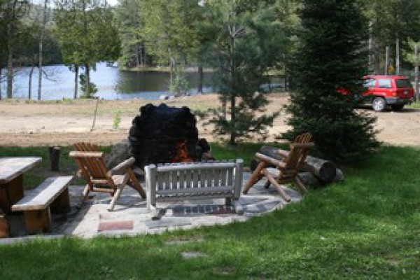 Fire pit with chairs and picnic table.
