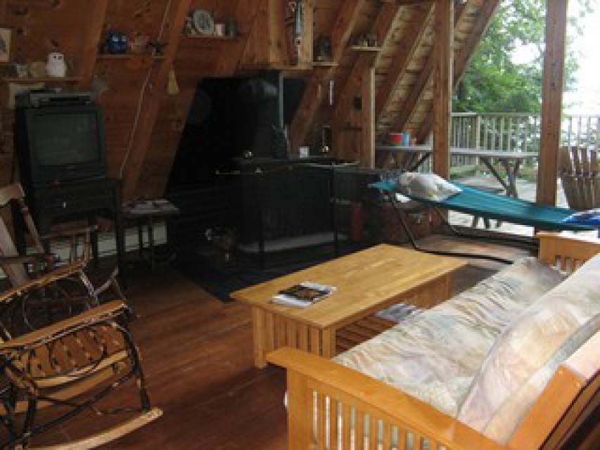futon, rocking chair, wood stove main room
