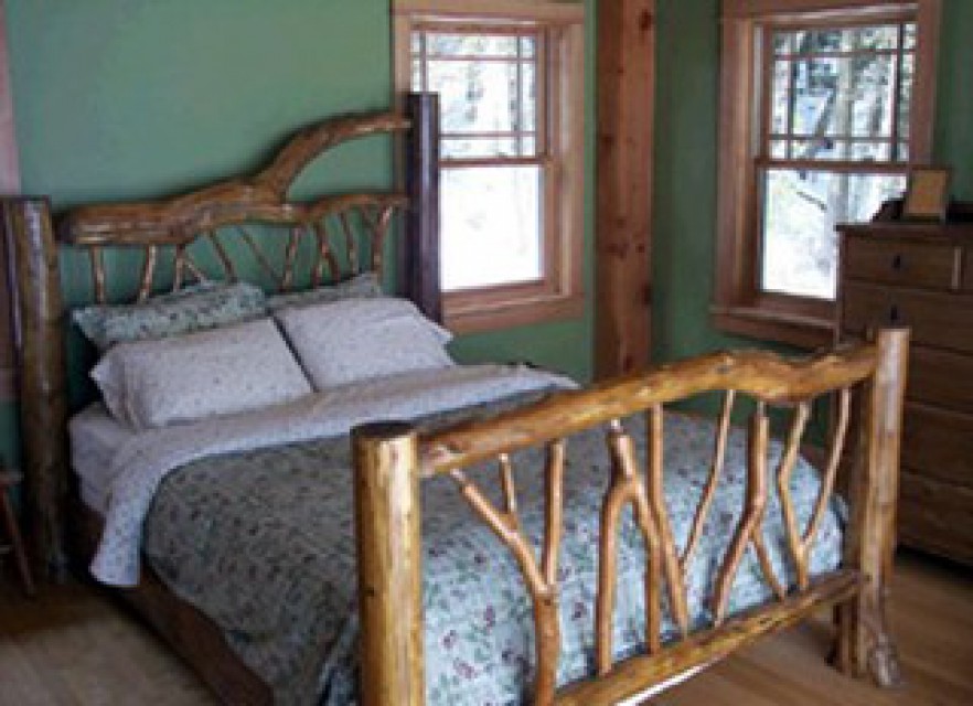 Second bedroom - queen bed, balcony, woodstove
