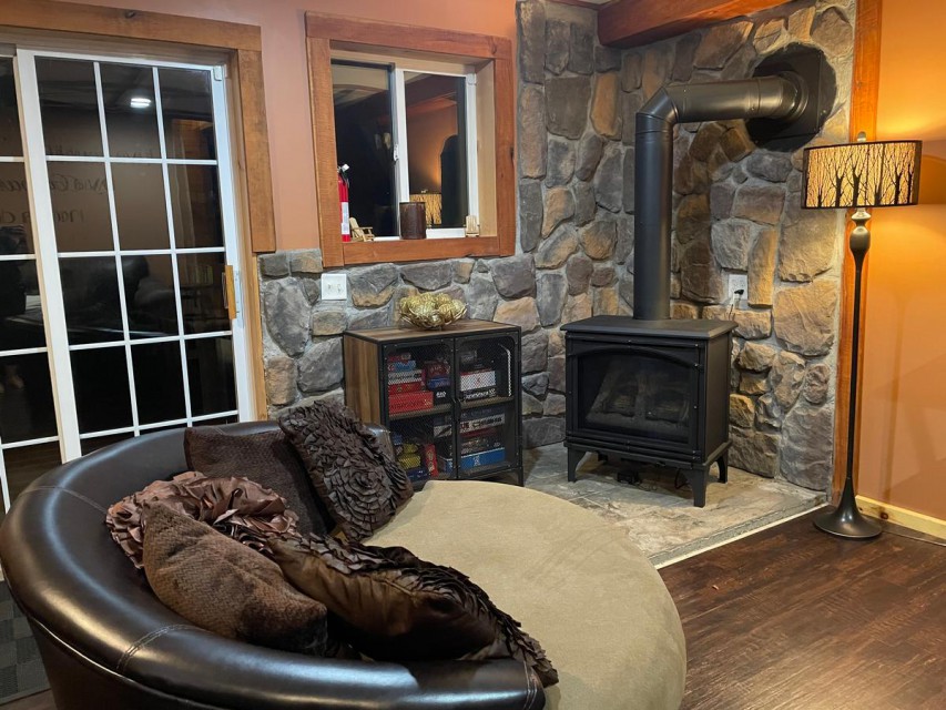 Lots of cozy seating, fireplace, game cabinet