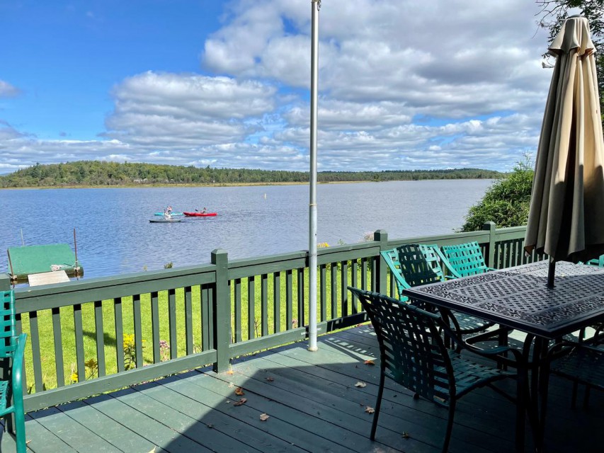 Front deck with dining table and beautiful view of lake