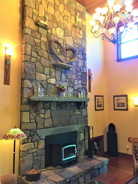 natural stone fireplace with woodstove insert