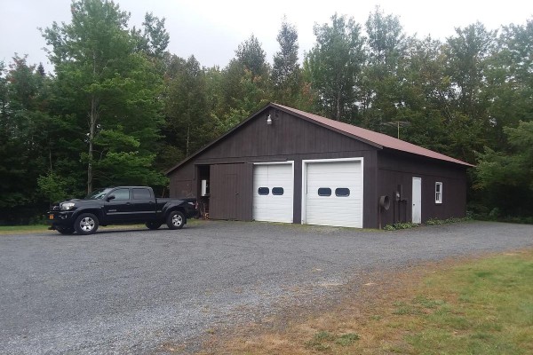 Over 1,300 sq ft - 4 car garage w/ two large sheds 