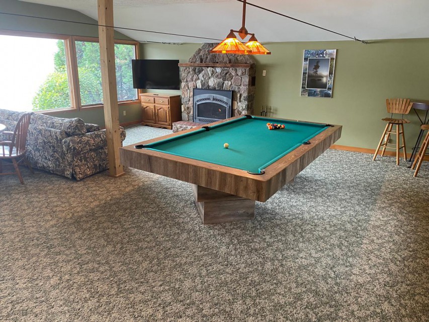 Detached cottage game room with fireplace and TV