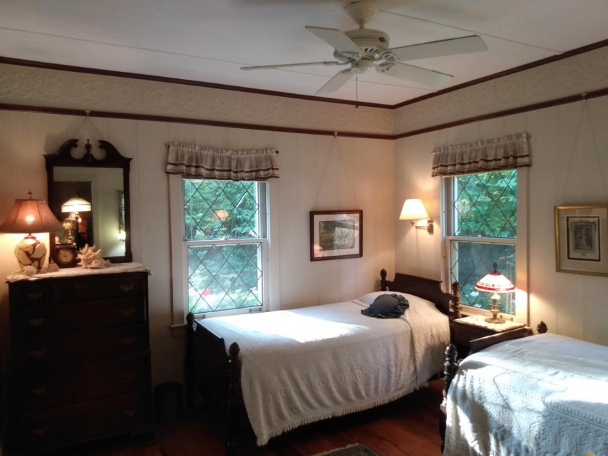 Woods bedroom with two extra long twin beds