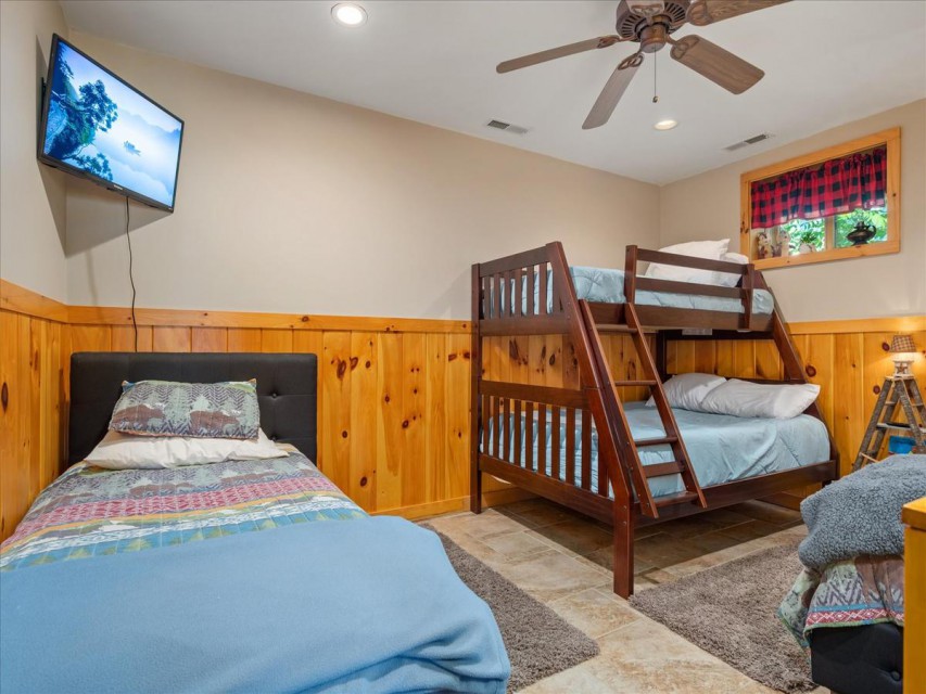 Lower level bunkroom with three twin and one full bed