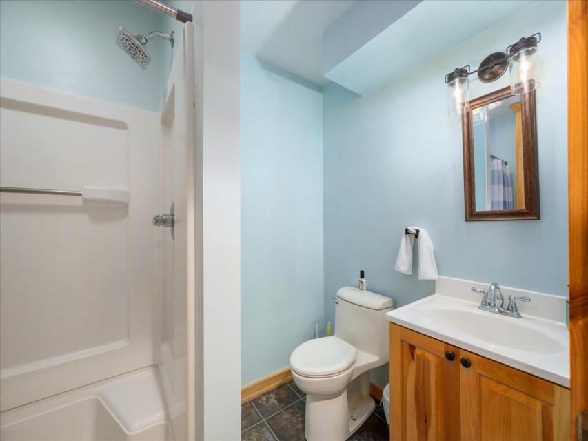 Lower level features full bath with large shower stall