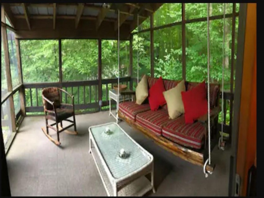 Covered screened porch nestled in the trees