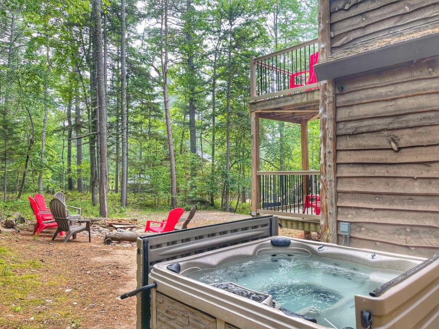 Luxurious hot tub, fire pit with plenty of seating.