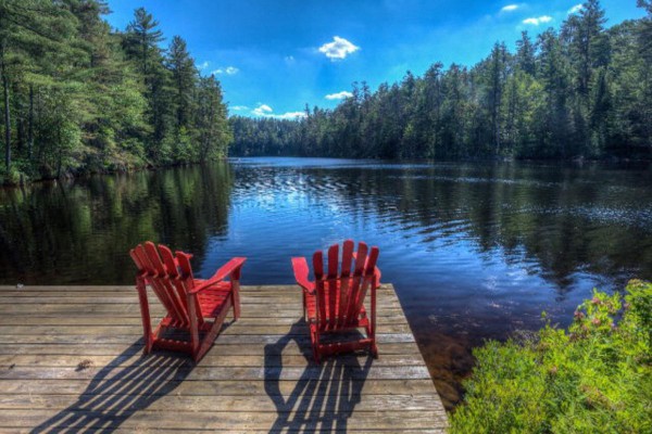 Red Adirondack chairs on Willow Camp's swimming dock