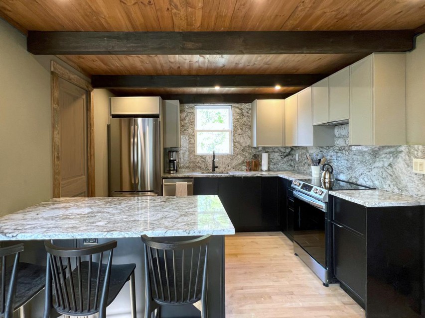 Spacious kitchen with granite countertops.