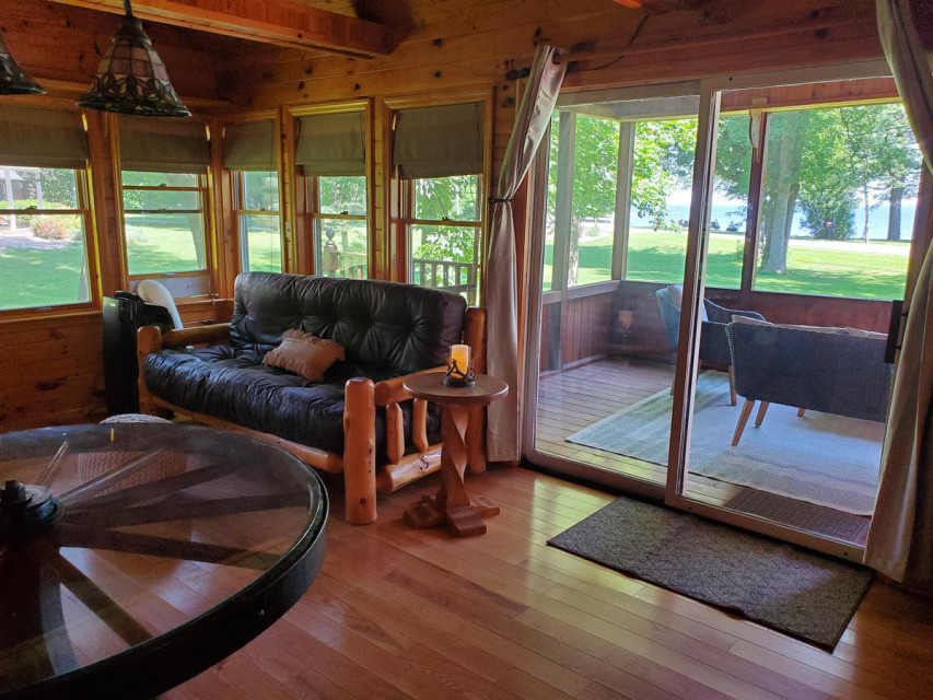 Living room with lake view and screen porch access