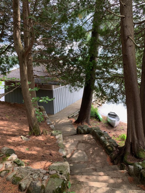 Stroll down stone steps and walkway to the canoe house